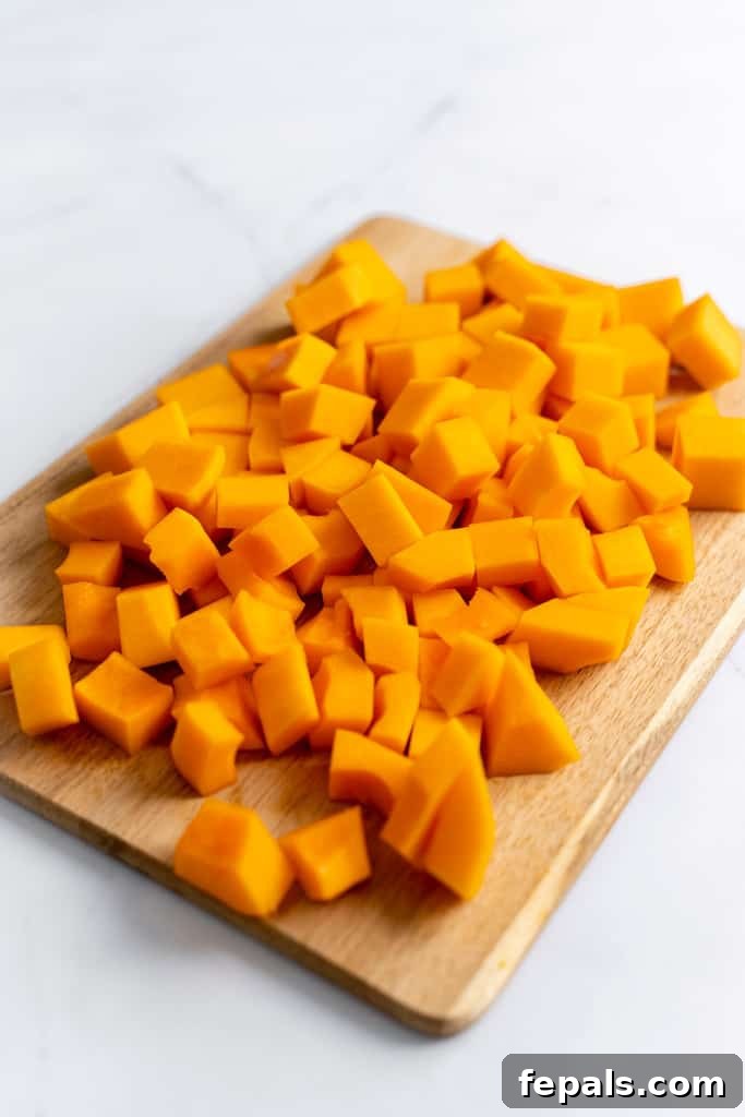 Effortless Butternut Squash Prep 6 Perfectly cut butternut squash cubes on a cutting board, ready for various recipes.