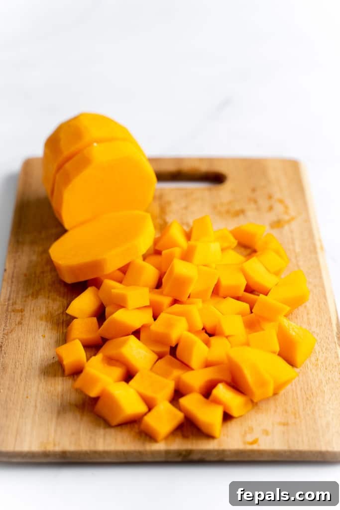 Effortless Butternut Squash Prep 7 Cubed butternut squash arranged neatly on a cutting board, ready for cooking or storage.