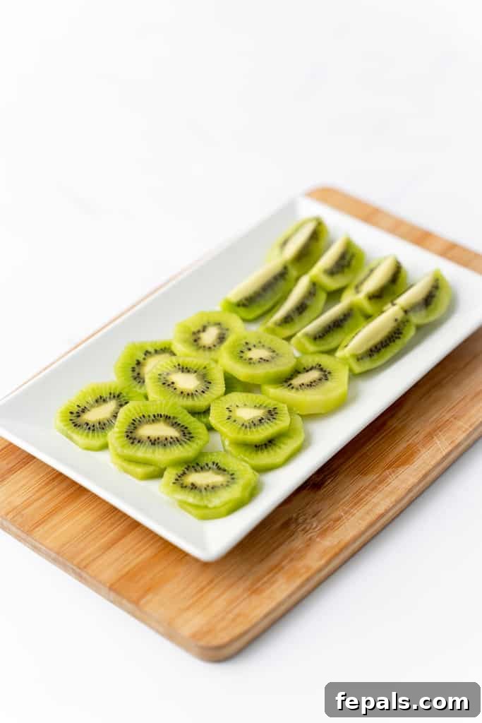 Effortless Kiwi Cutting Techniques 13 Angled view of cut kiwi on a serving plate.