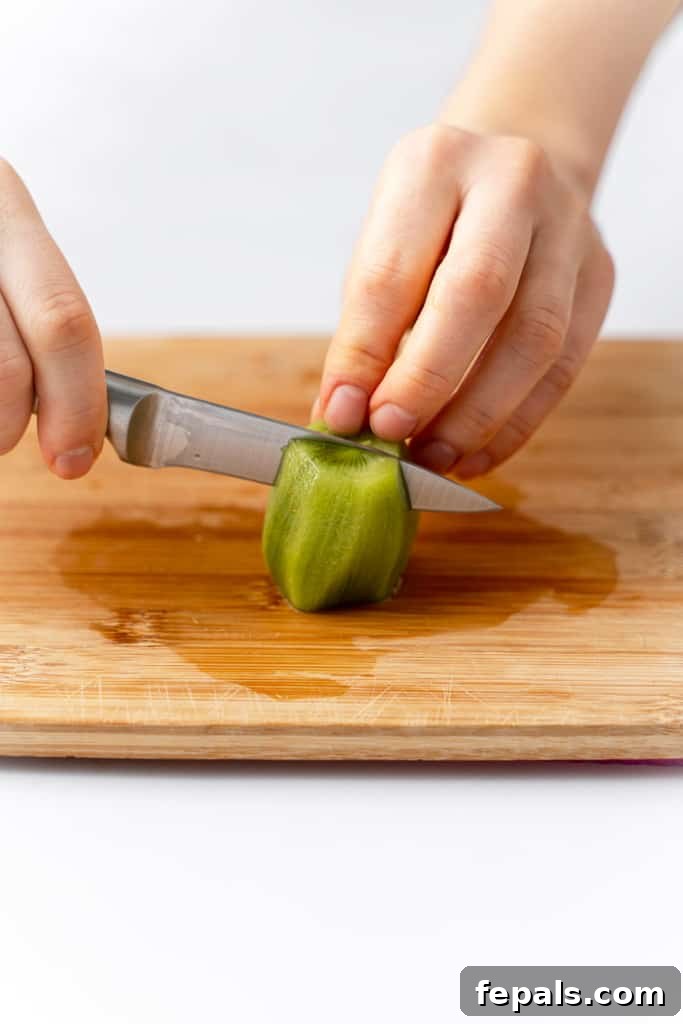Effortless Kiwi Cutting Techniques 10 Peeled kiwi, cut in half.
