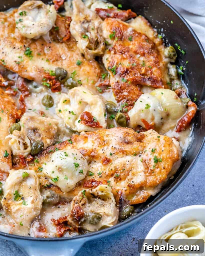Zesty Mediterranean Skillet Chicken 10 side shot of chicken breast in a Mediterranean lemon sauce in black skillet