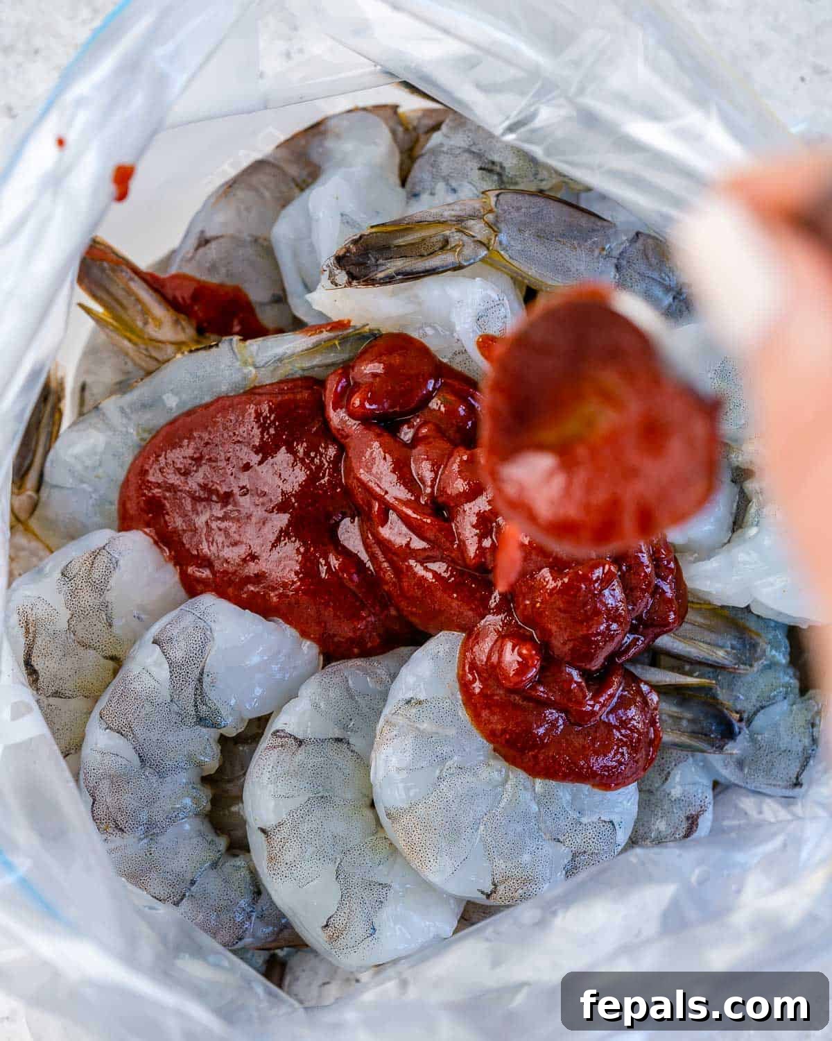 Smoky BBQ Shrimp 5 bbq sauce being poured over shrimp in ziplock bag