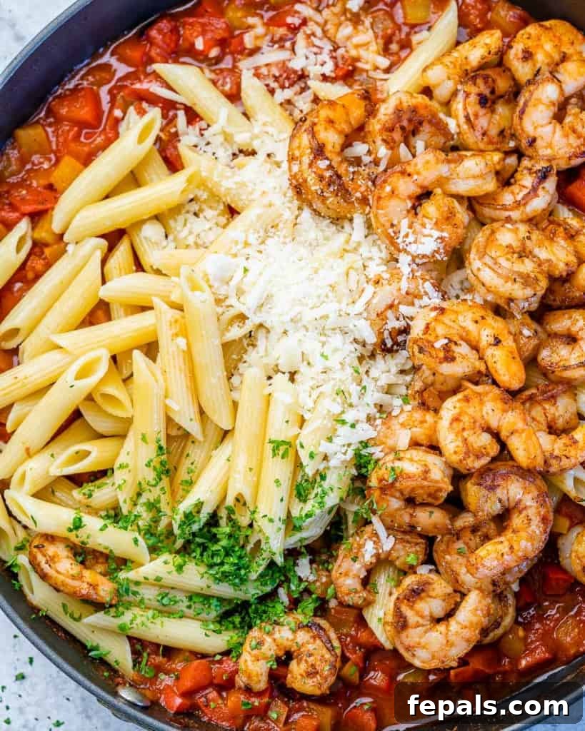 top view of pasta and shrimp over tomato sauce