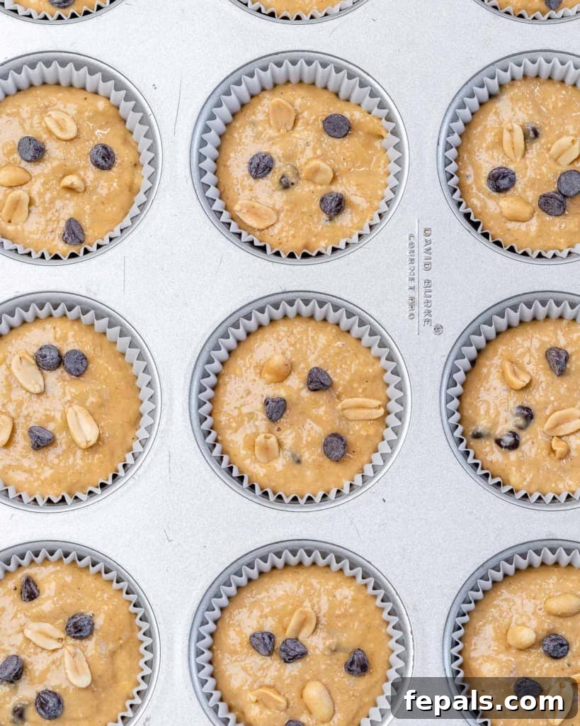 muffin batter poured on muffin pan before baking
