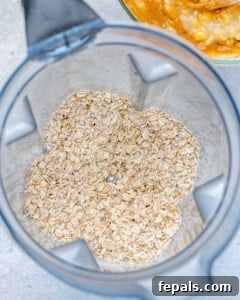 Chewy Raisin Oat Delights 14 Rolled oats in a blender, ready to be coarsely ground.
