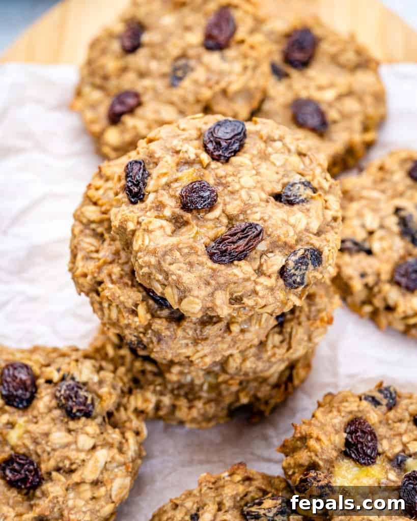 Chewy Raisin Oat Delights 9 A top-down view of several stacks of healthy oatmeal raisin cookies, highlighting their soft texture and golden color, ready for sharing.