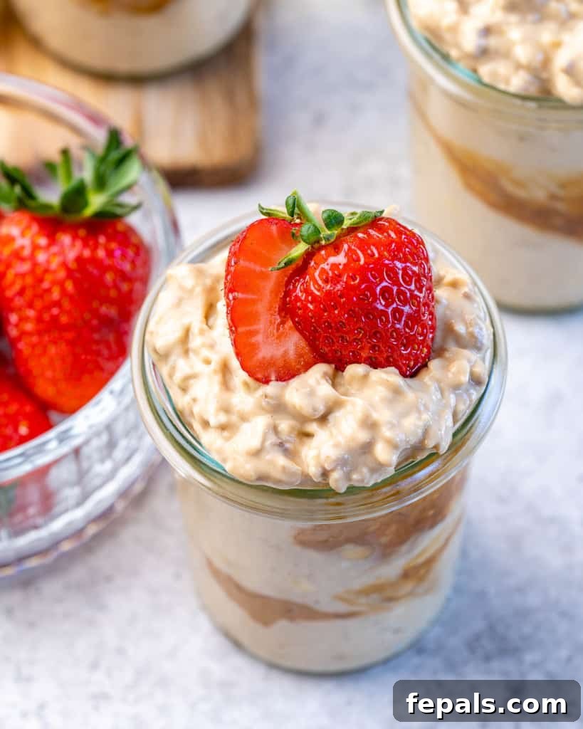 Creamy Peanut Butter Protein Overnight Oats 3 top view of peanut butter overnight oats in a jar and topped with fresh strawberries