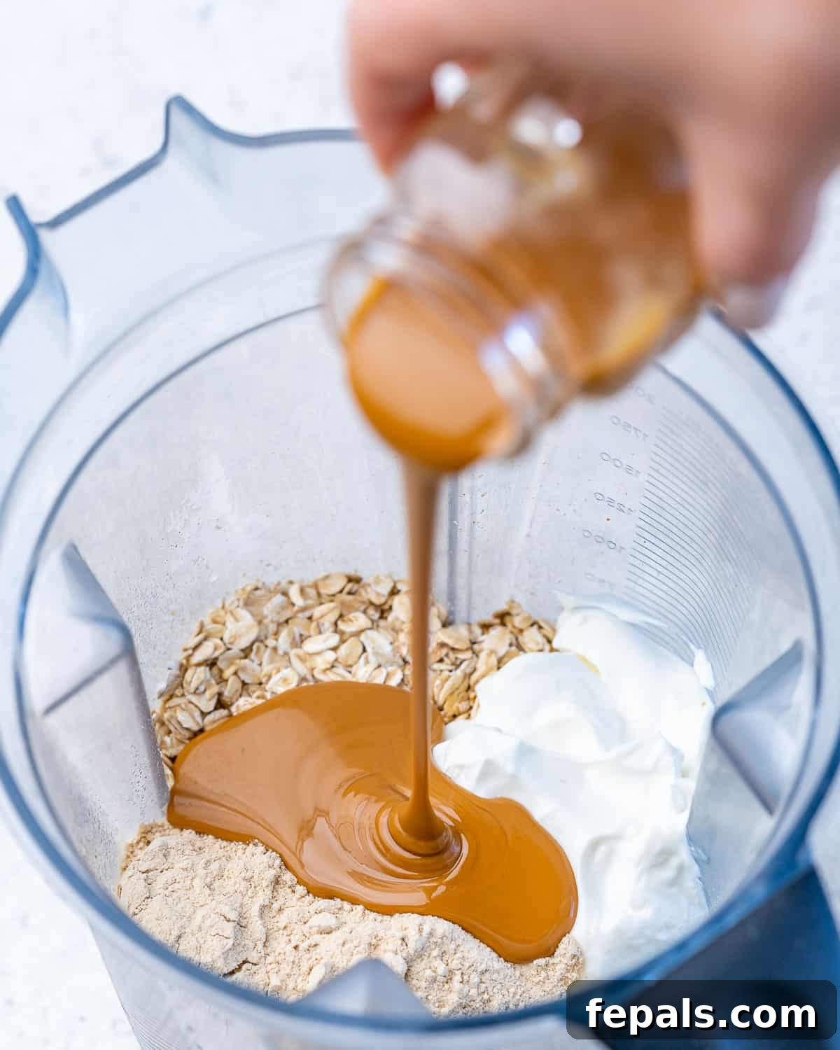 Creamy Peanut Butter Protein Overnight Oats 5 ingredients to make overnight oats with peanut butter being poured into the blender