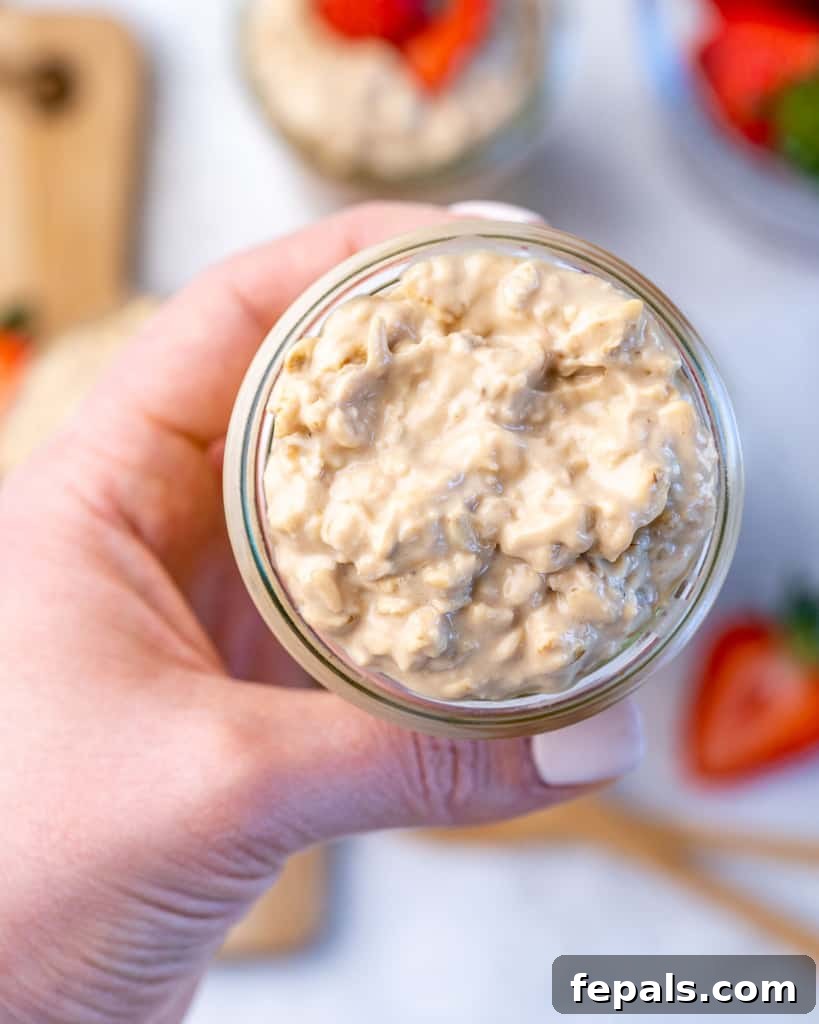 Creamy Peanut Butter Protein Overnight Oats 7 hand holding overnight oats in a jar