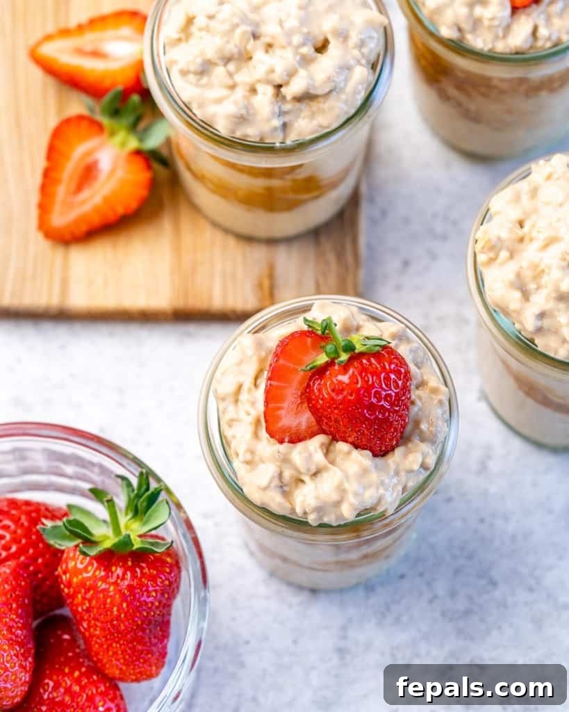 Creamy Peanut Butter Protein Overnight Oats 10 top view overnight oats in mason jars with strawberries