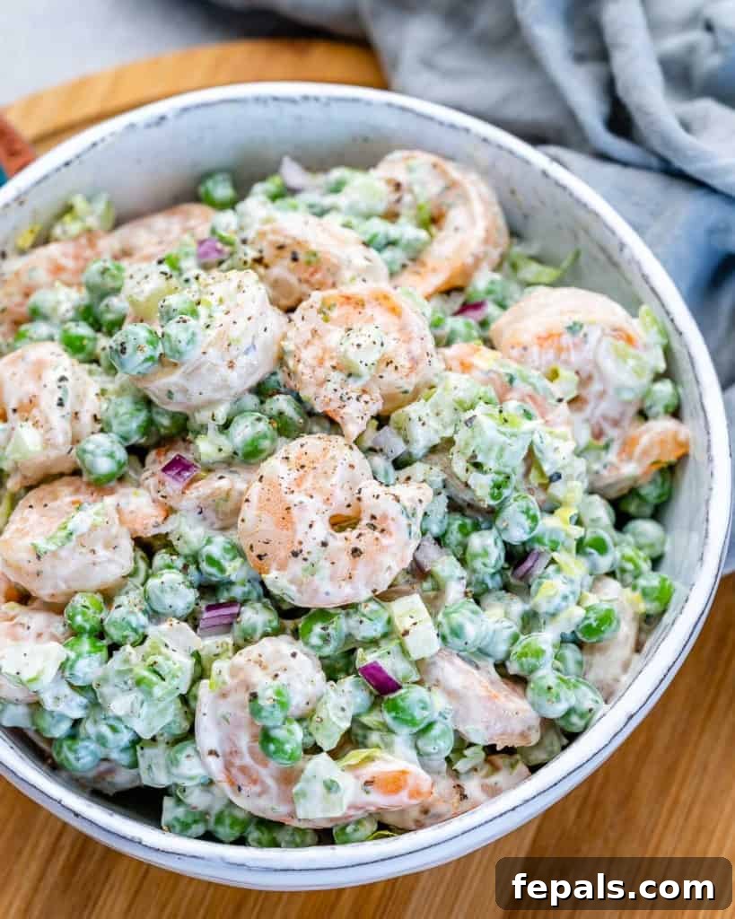 Refreshing Shrimp Salad 3 Side shot of creamy shrimp salad with vibrant green peas, showcasing its texture
