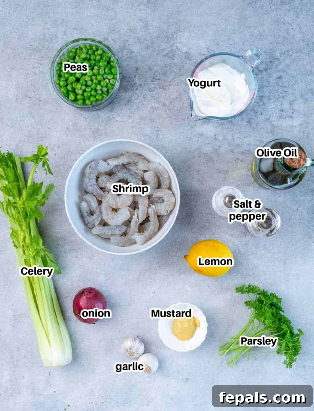 Refreshing Shrimp Salad 4 A visual spread of fresh ingredients laid out for making the healthy shrimp salad, including raw shrimp, lemon, yogurt, mustard, and vegetables.