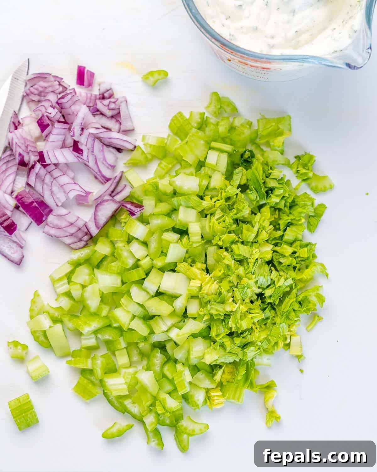 Refreshing Shrimp Salad 5 A close-up view of chopped celery and minced red onions, ready to be added to the salad