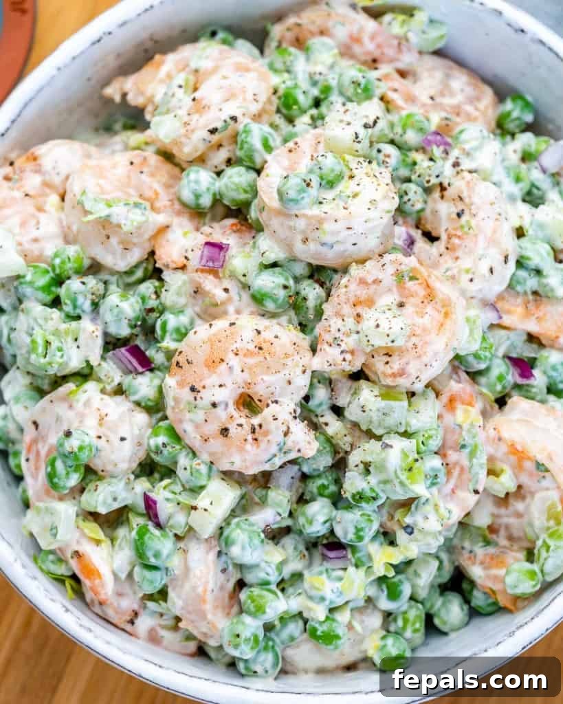 Refreshing Shrimp Salad 7 A close-up shot of the creamy shrimp salad in a white bowl, highlighting the tender shrimp and fresh vegetables.