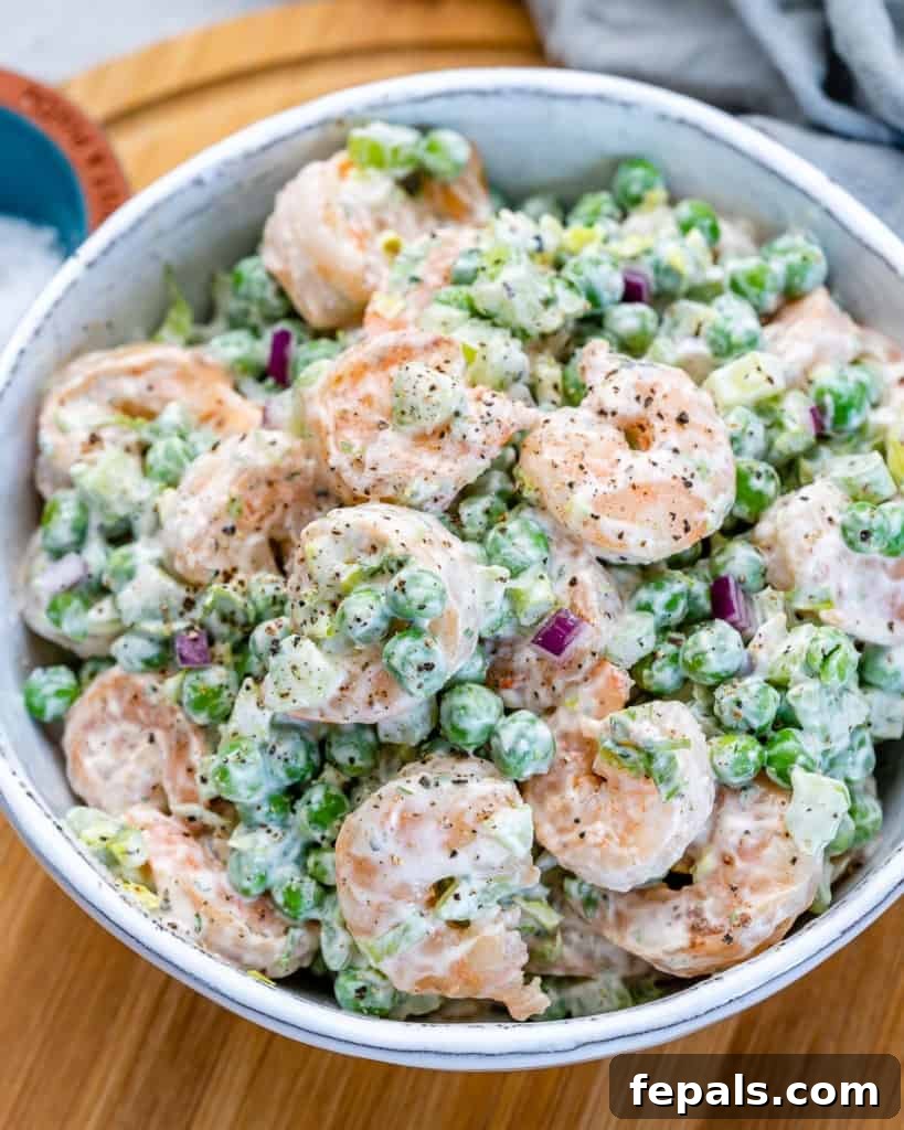 Refreshing Shrimp Salad 9 Side shot of creamy shrimp salad presented attractively in a rustic white bowl.
