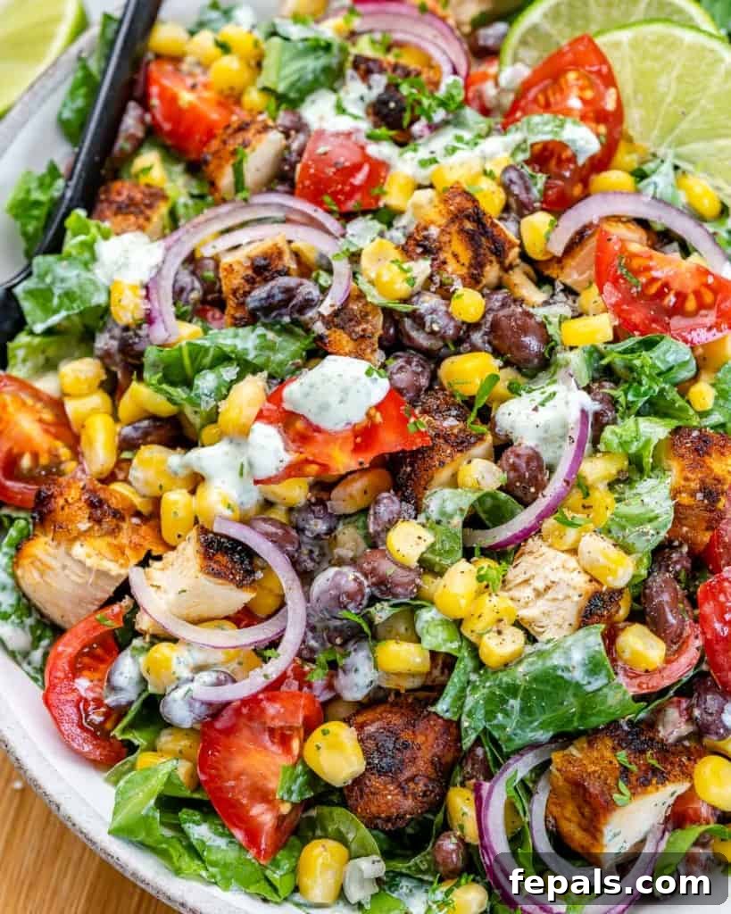 Fiesta Grilled Chicken Salad 5 Close up view of colorful chopped chicken salad with visible dressing.