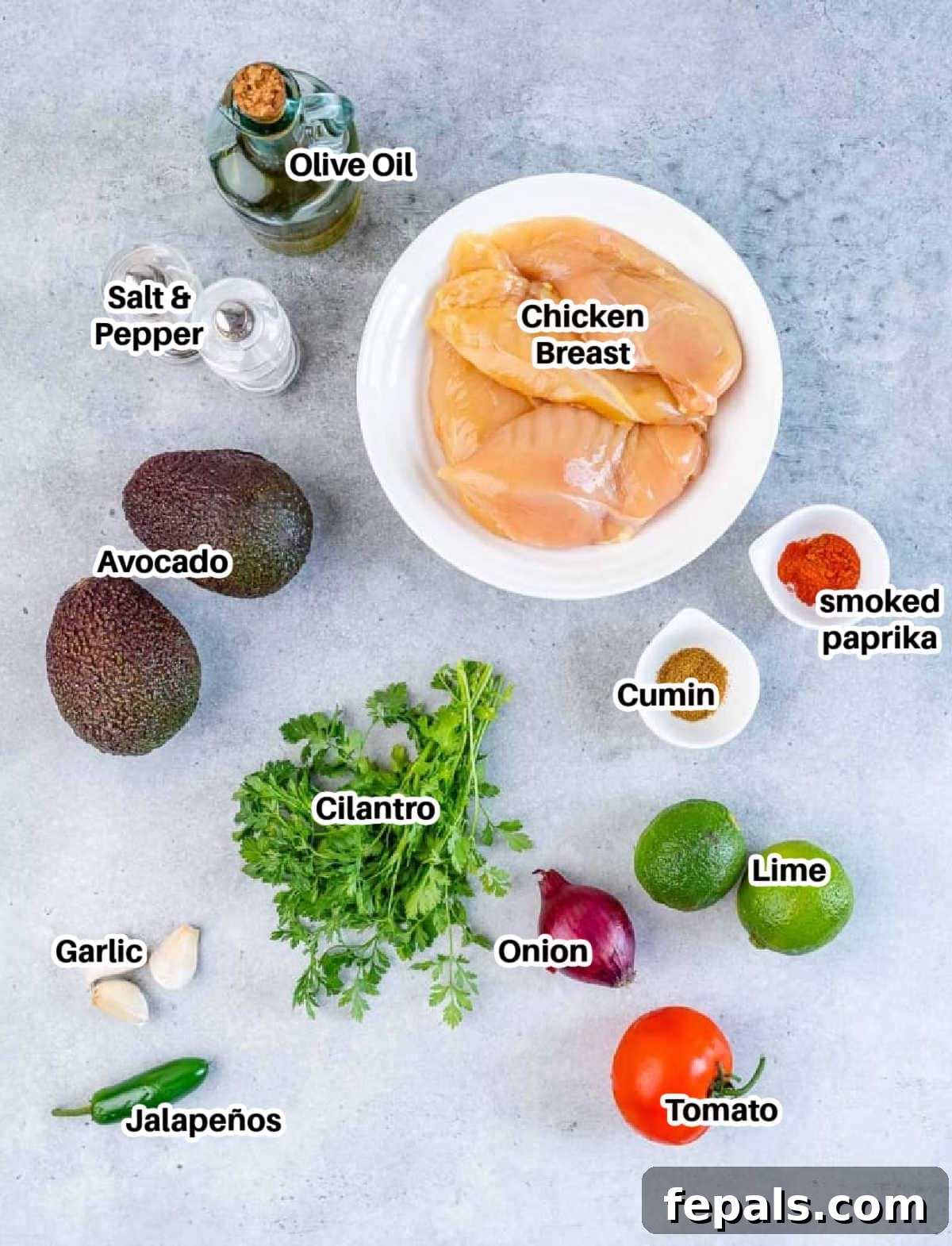 Smoky Grilled Chicken with Zesty Avocado Salsa 4 A beautiful flat lay of all the fresh ingredients required: raw chicken breasts, whole avocados, vibrant tomatoes, limes, cilantro, minced garlic, and various spices, ready for making grilled chicken and avocado salsa.