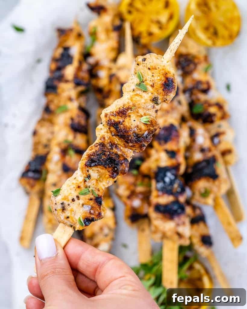 close view of grilled chicken kabob with lemon and pepper, showing tender meat