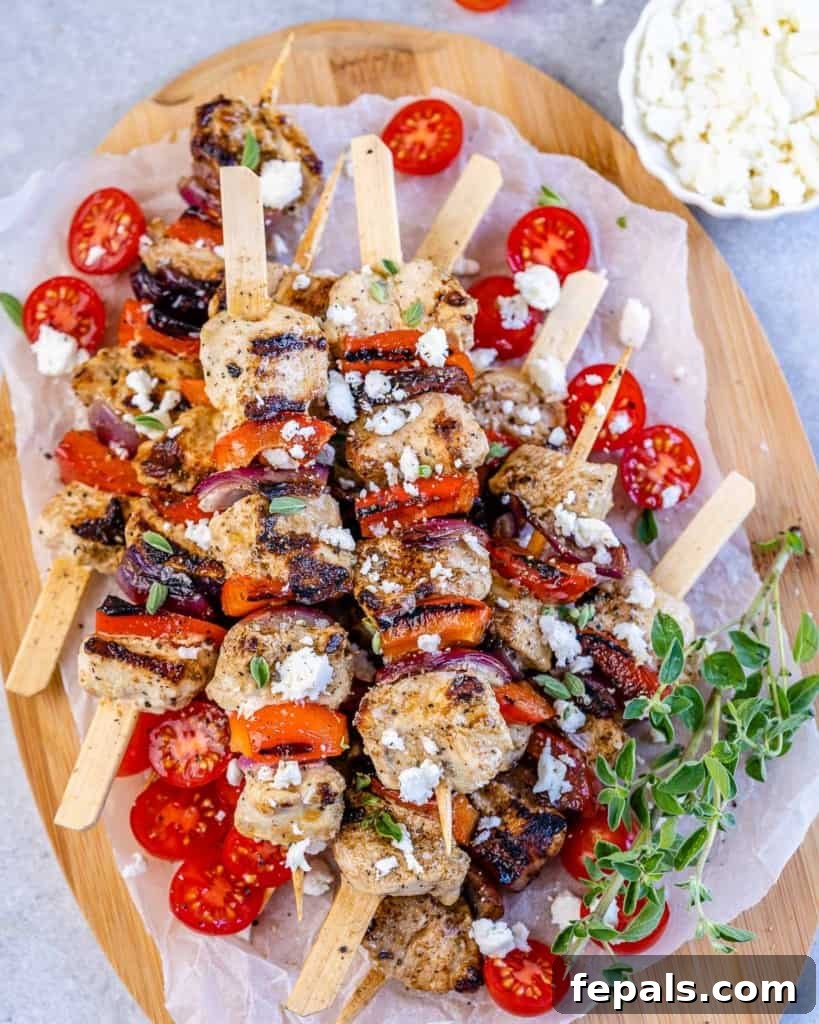 top view chicken skewers on a white plate