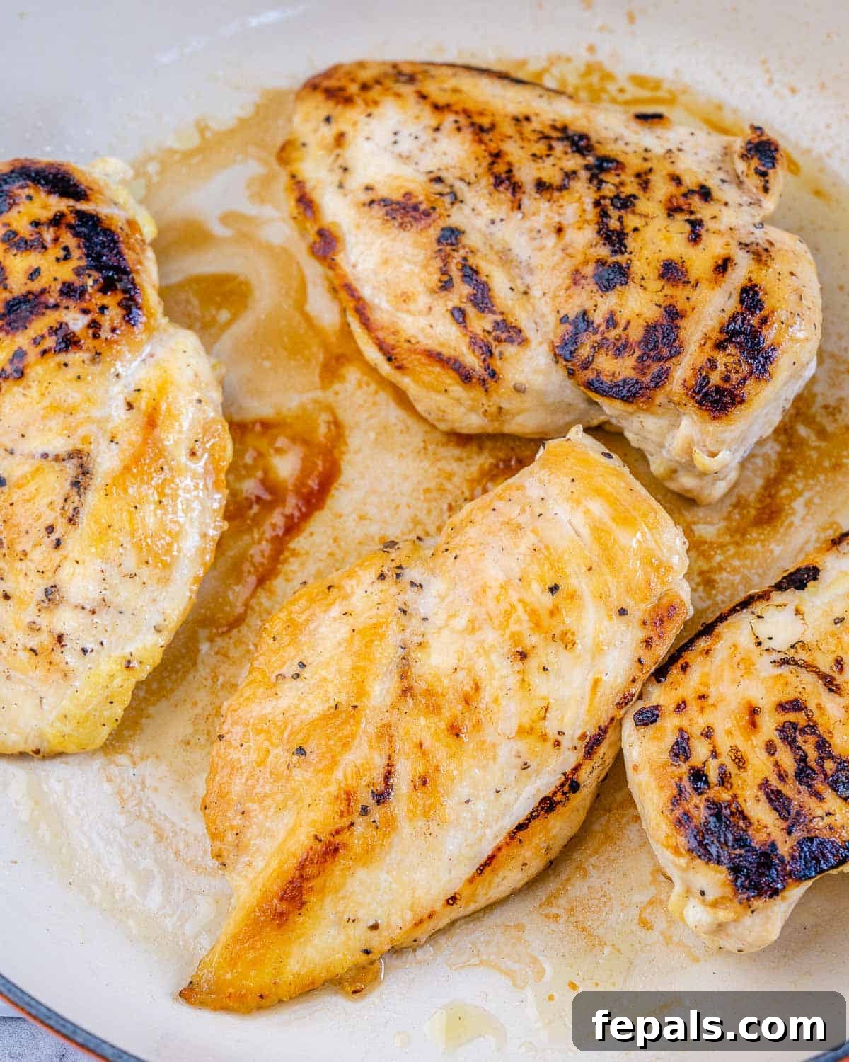 Smoky Chipotle Chicken Skillet 5 Cooked chicken breast nestled in a creamy chipotle sauce in a skillet, ready for final simmering.