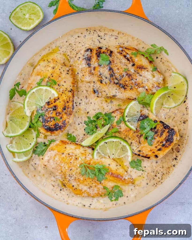 Smoky Chipotle Chicken Skillet 8 A large skillet containing creamy chipotle chicken, garnished generously with fresh cilantro and lime wedges.