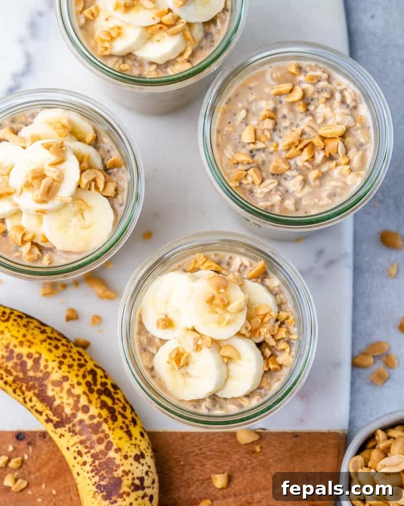 Top view of peanut butter banana overnight oats in jars with banana slices and chopped peanuts as garnish.