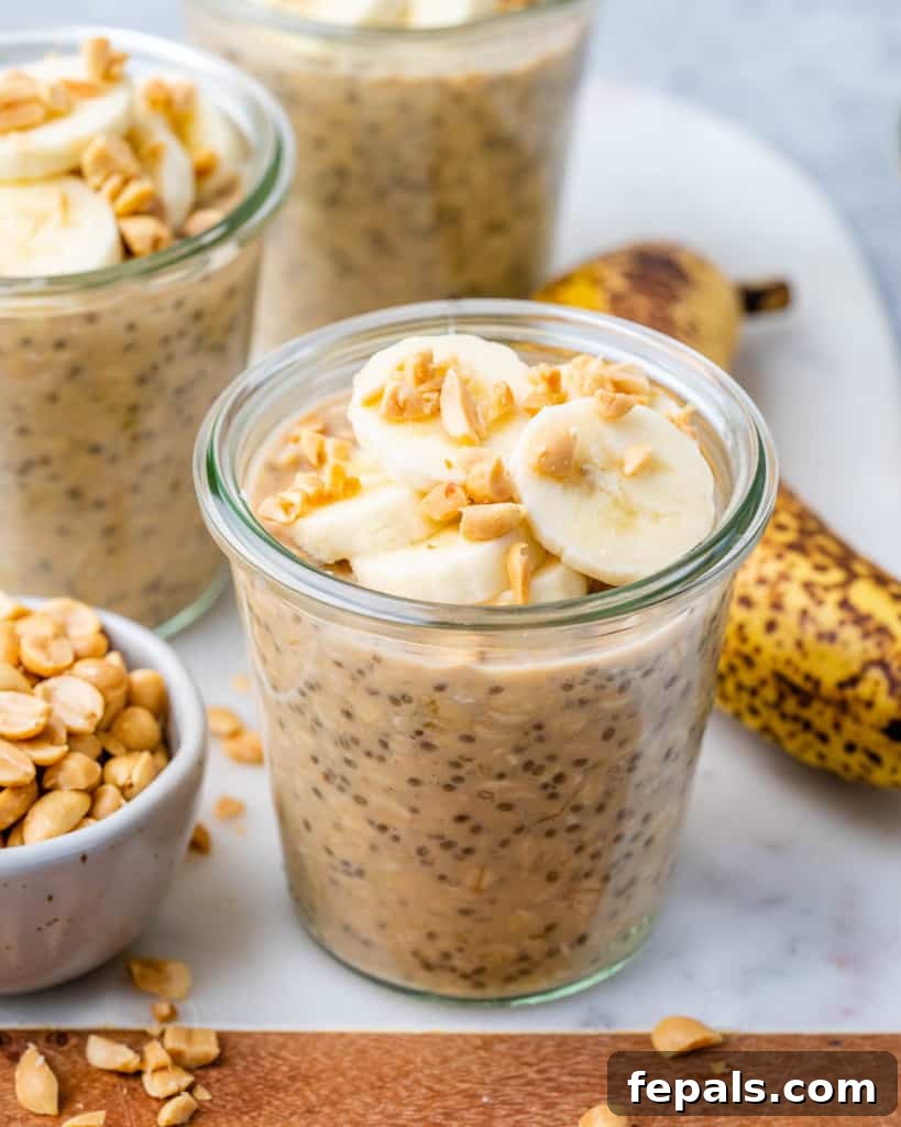 Front view of overnight oats in a jar, topped with freshly sliced bananas and a swirl of peanut butter.