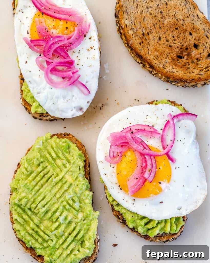 top view avocado toast with eggs and pickled onions