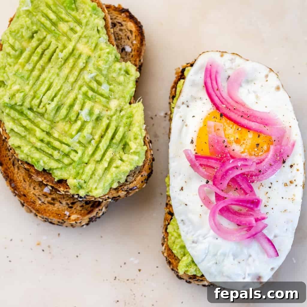 top view of two avocado toast, one with eggs and one without 