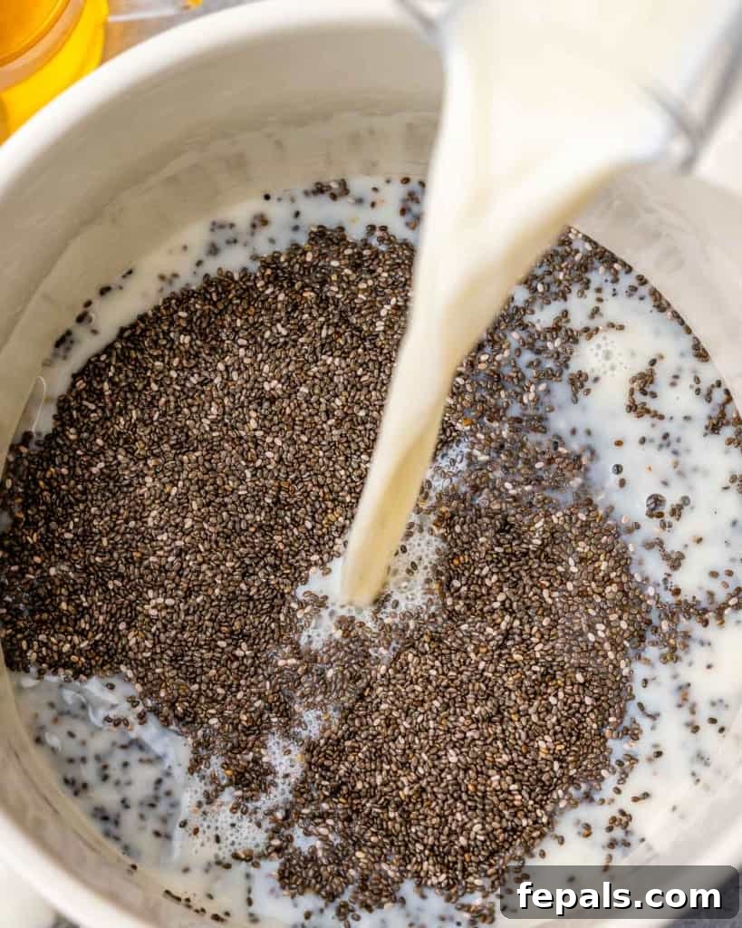 Creamy Chia Pudding Perfection 5 almond milk being poured over chia seeds in a bowl