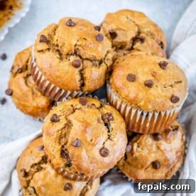 Wholesome Flourless Peanut Butter Banana Muffins 11 Stacks of peanut butter muffins made with chocolate chips next to each other.