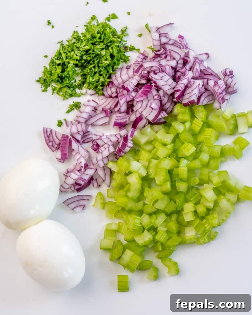 Cauliflower Mock Potato Salad 6 Chopped hard-boiled eggs, red onion, celery, and fresh parsley, ready to be added to the cauliflower potato salad.