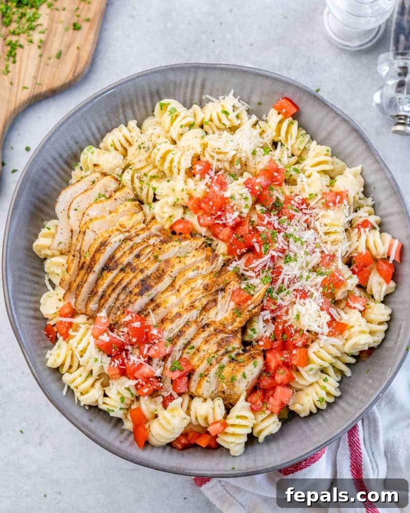 A perfectly plated serving of rich chicken pasta in a gray dish, highlighting its creamy texture and appetizing presentation.