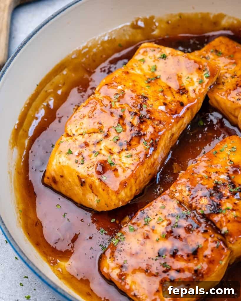 Side shot of honey glazed salmon fillets, rich in color and texture.