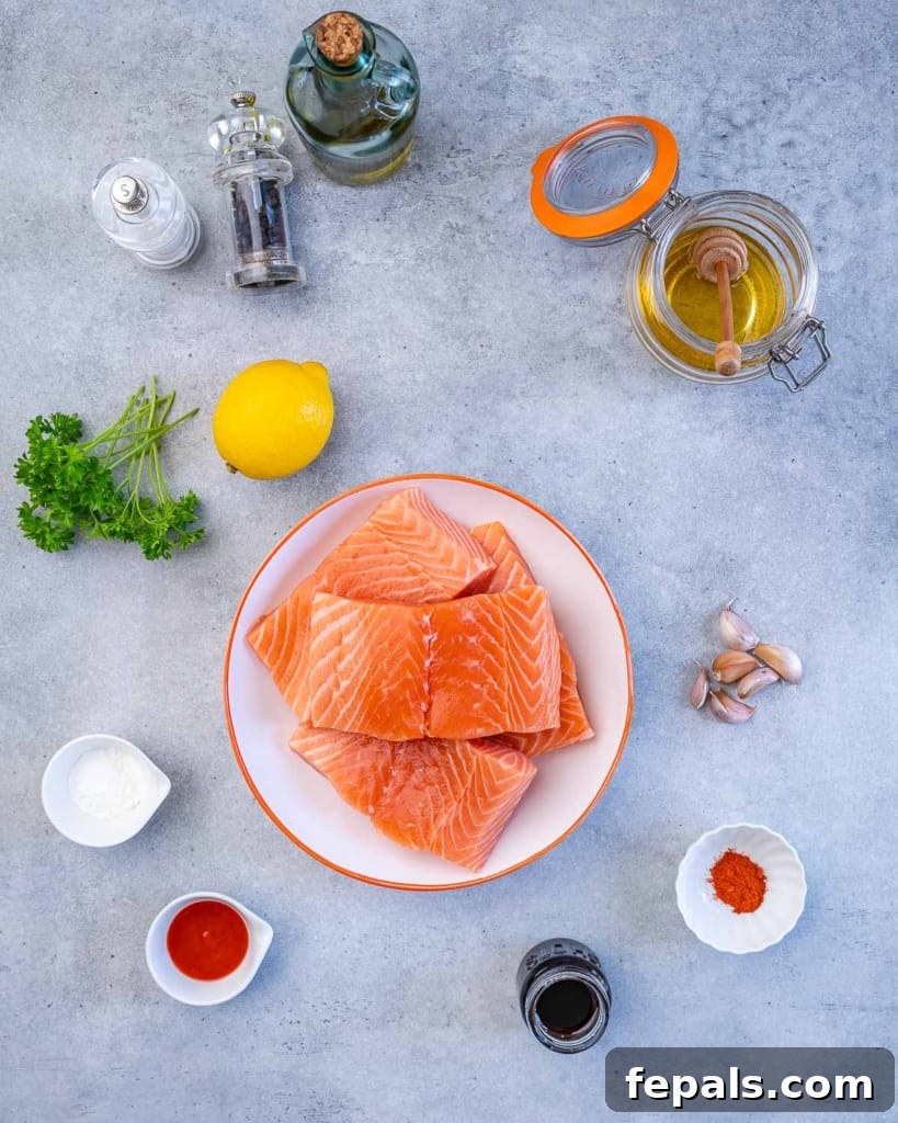 Assorted ingredients for pan-seared honey garlic salmon laid out on a kitchen counter.