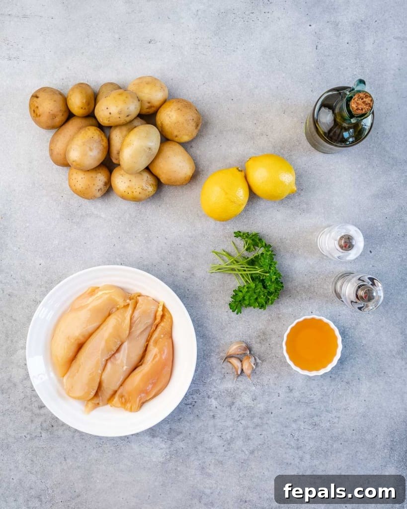 raw ingredients for honey lemon chicken and potatoes: lemons, honey, olive oil, garlic, salt, pepper, chicken breasts, and baby potatoes