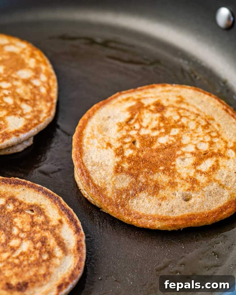 Wholesome Banana Oat Flapjacks 6 pancakes cooking on pan