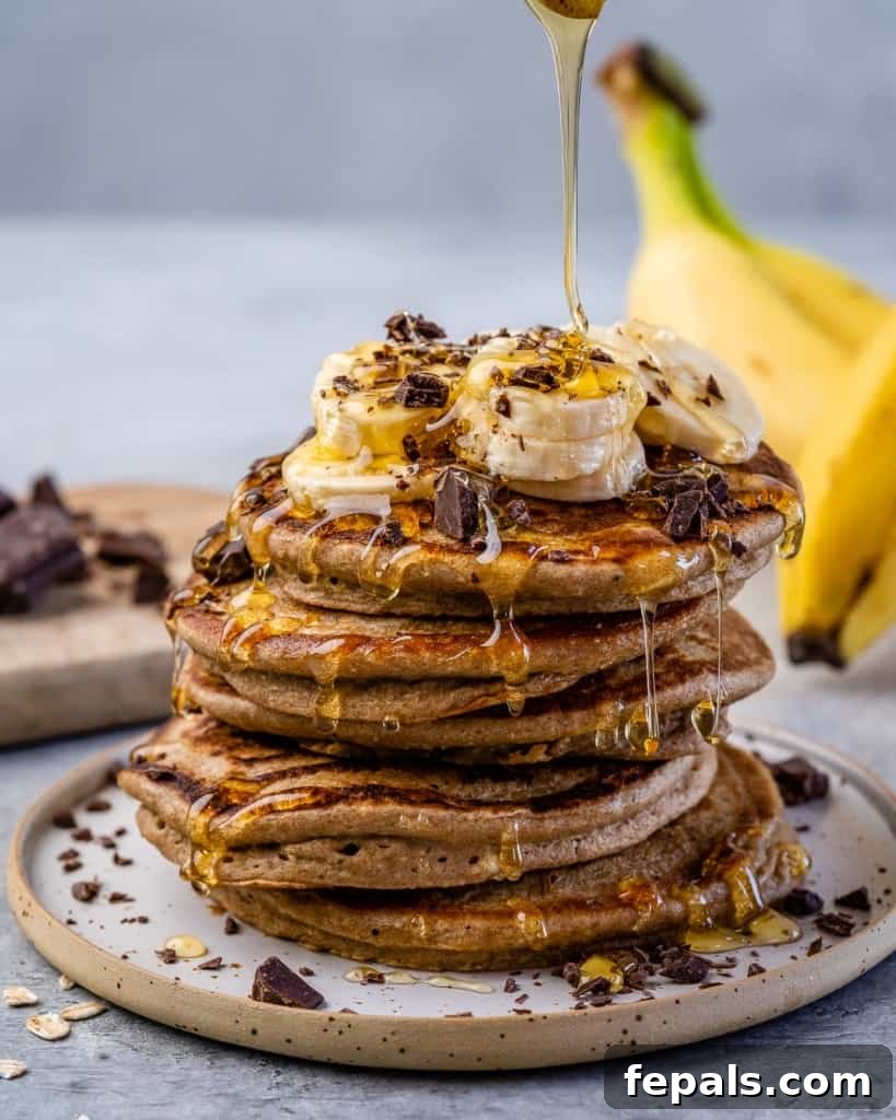 Wholesome Banana Oat Flapjacks 8 front stack of banana pancakes with syrup