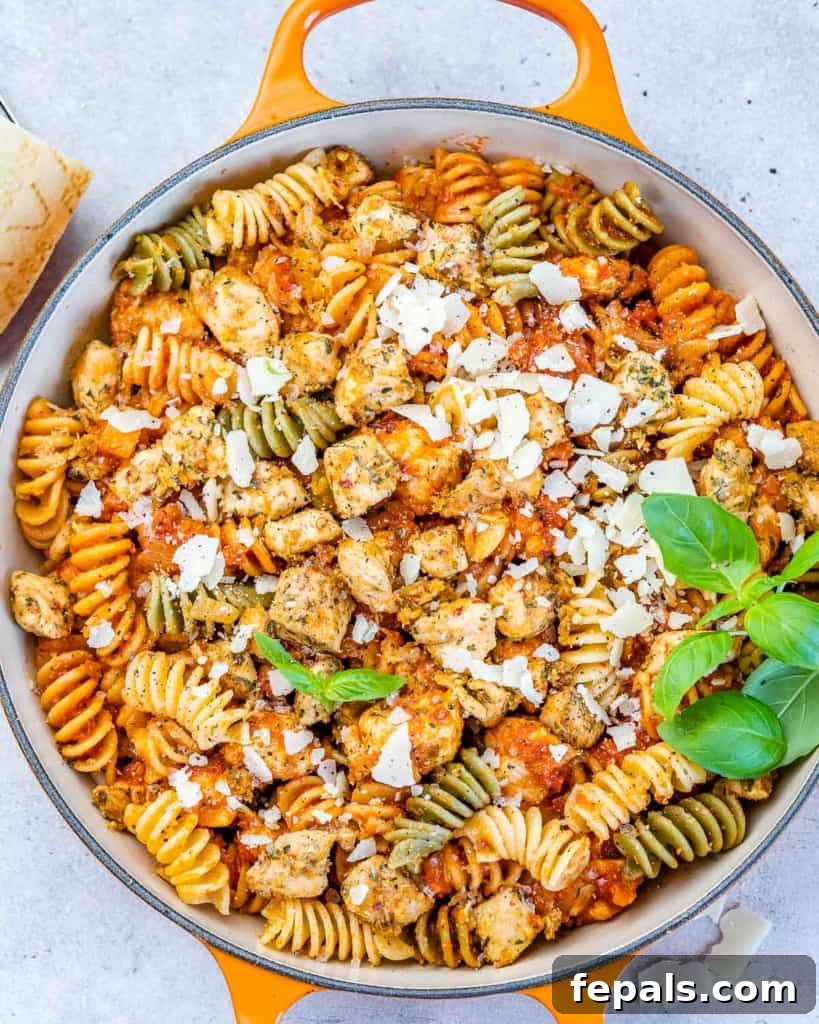 Comforting Chicken Parmesan Pasta 7 top view of chicken pasta in an orange skillet