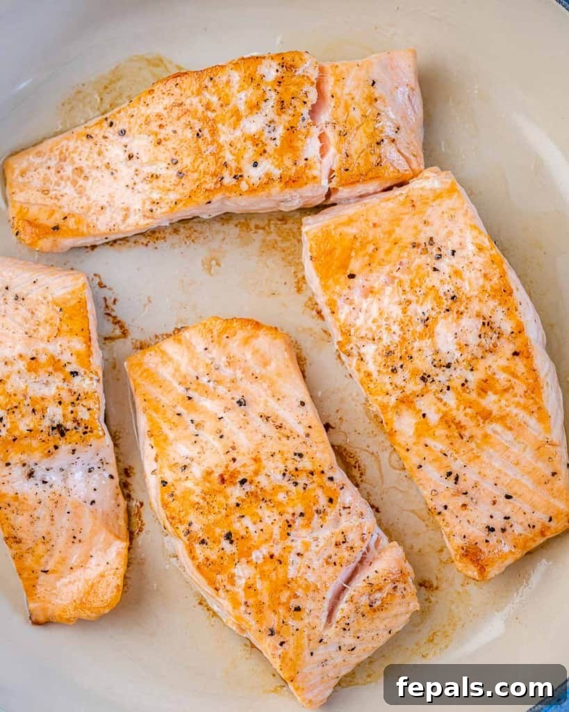 Sweet and Sticky Pan Seared Salmon 5 cooked salmon fillets in a pan