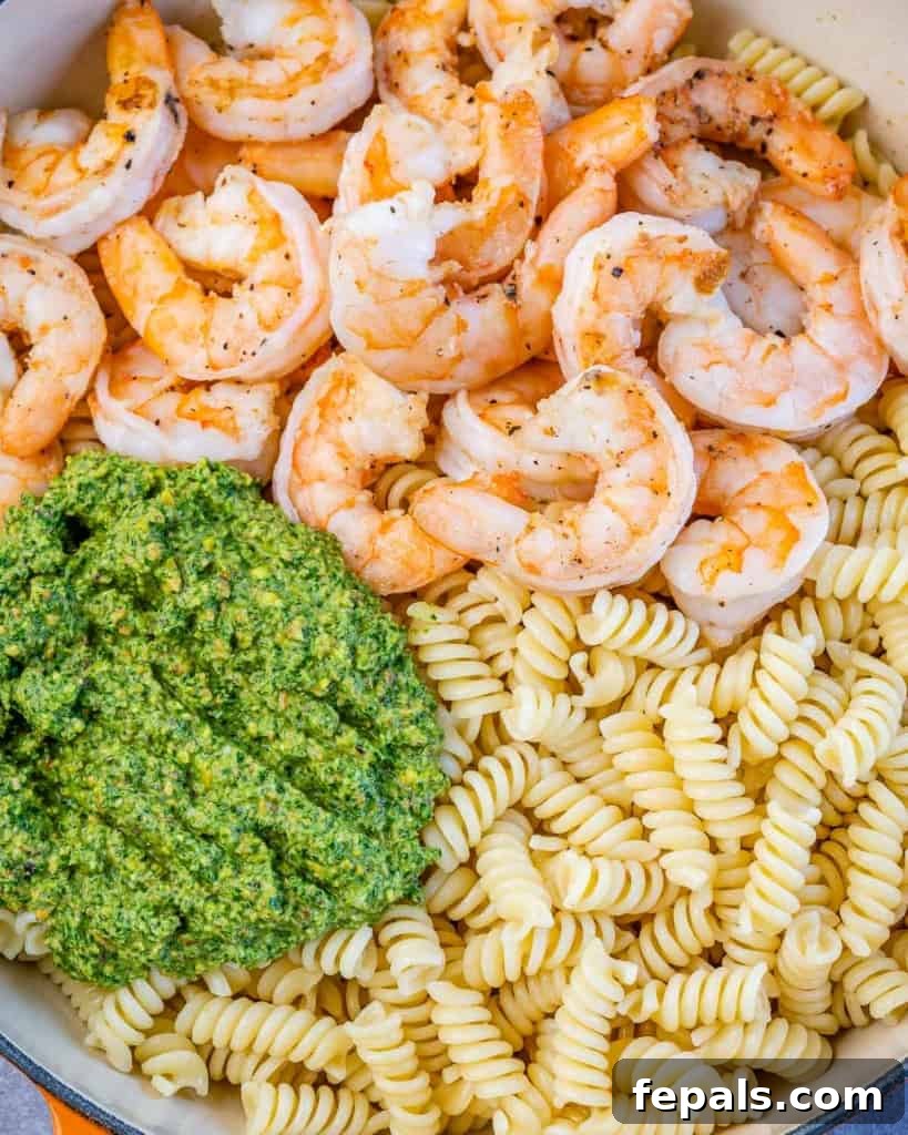 pasta, shrimp, and pesto added to pan 