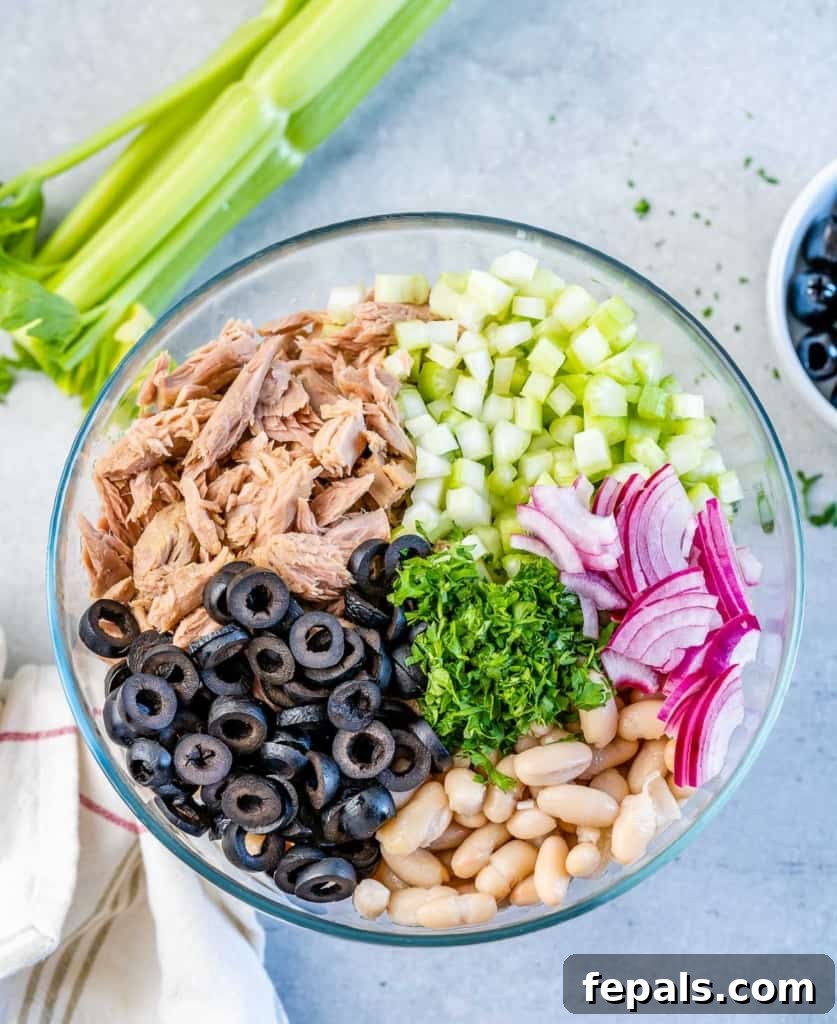Wholesome White Bean Tuna Medley 6 all tuna salad ingredients added to a clear bowl ready to be mixed