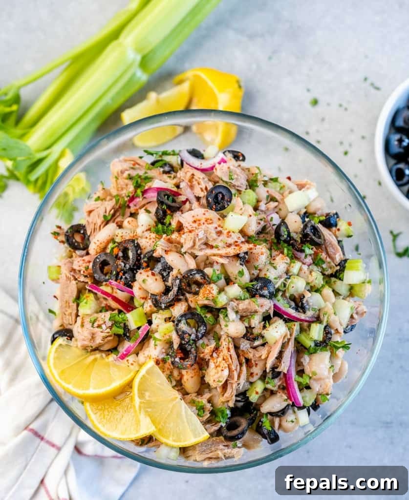 Wholesome White Bean Tuna Medley 9 top view of tuna salad on a clear bowl with lemon garnishes