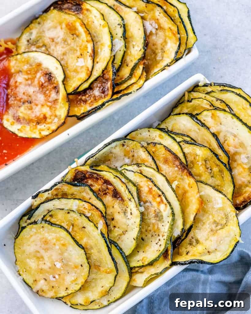 Crispy Air Fryer Zucchini Bites 9 top view or zucchini chips lined in a white dish