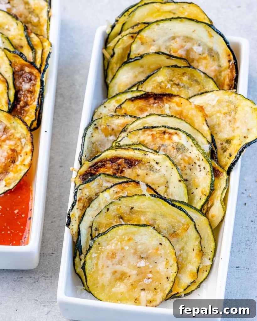 Crispy Air Fryer Zucchini Bites 10 top view of zucchini chips line up in a white dish