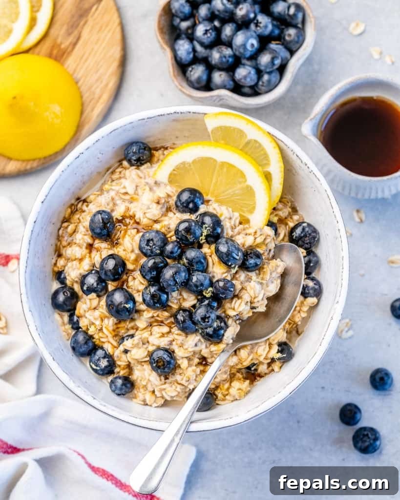 Berry Bliss Overnight Oats 4 Overnight oatmeal with a generous topping of fresh blueberries and lemon wedges, showing its creamy texture.