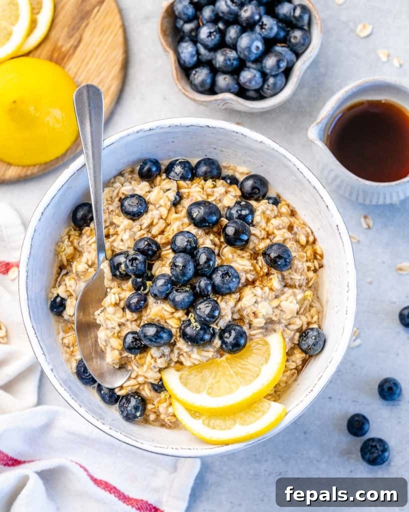 Berry Bliss Overnight Oats 10 A vibrant bowl of blueberry overnight oats, artfully arranged with fresh blueberries and lemon slices for a visually appealing and healthy breakfast.