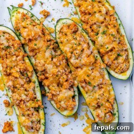 Top view of 4 zucchini boats stuffed with buffalo chicken