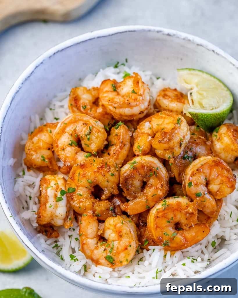 top close up view of cooked shrimp over a bowl of white rice