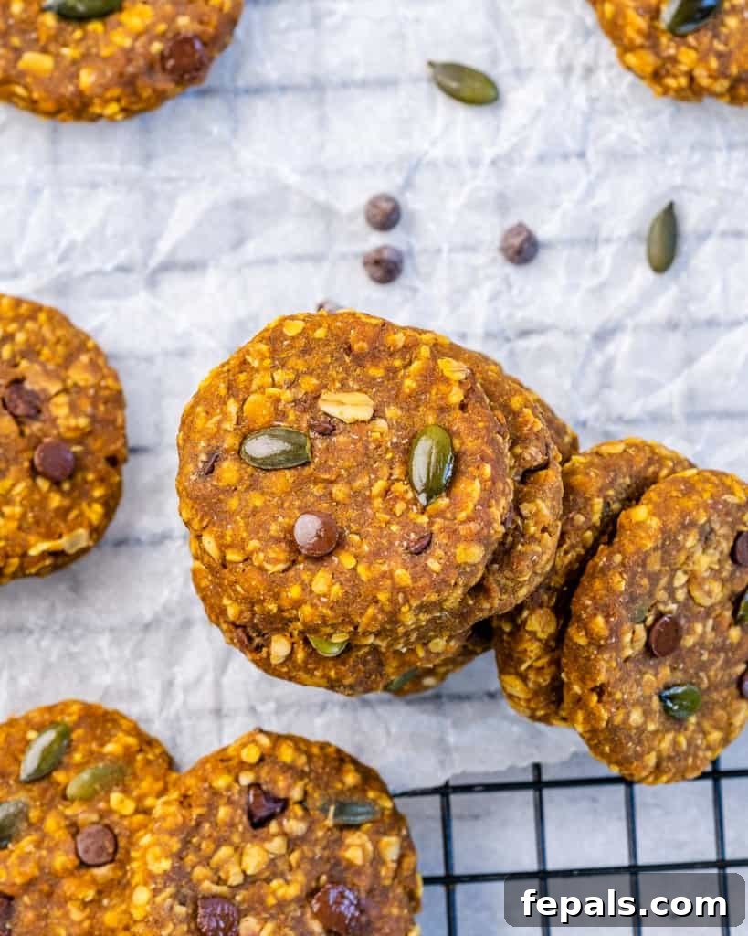 Spiced Pumpkin Oat Delights 9 Top view of stacks of healthy pumpkin oatmeal cookies on a cooling rack, perfectly golden and ready to enjoy